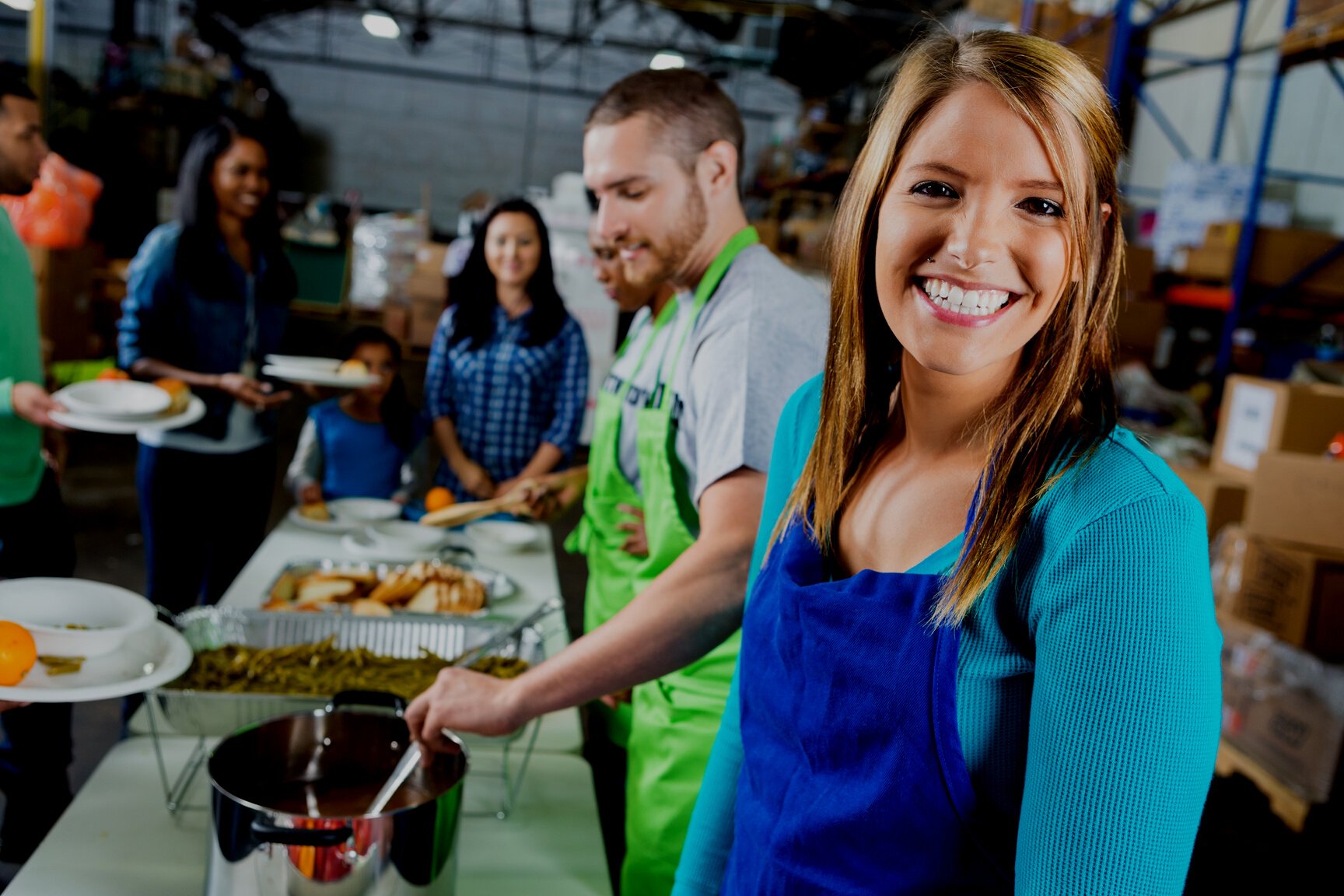 Woman serves food in community soup kitchen